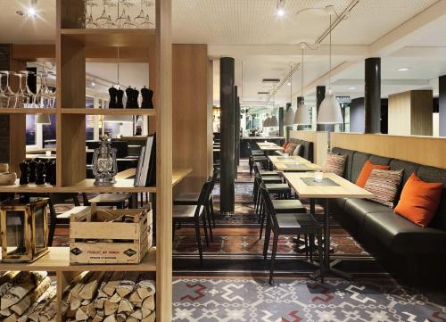 a restaurant with a row of tables and chairs at Break Sokos Hotel Koli in Kolinkylä
