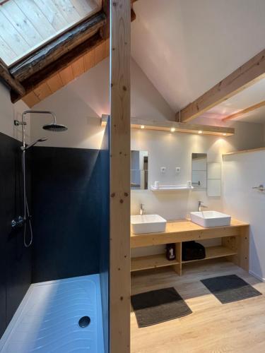 a bathroom with two sinks and a shower at Spacious town house in the center of le Bourg d'Oisans in Le Bourg-dʼOisans