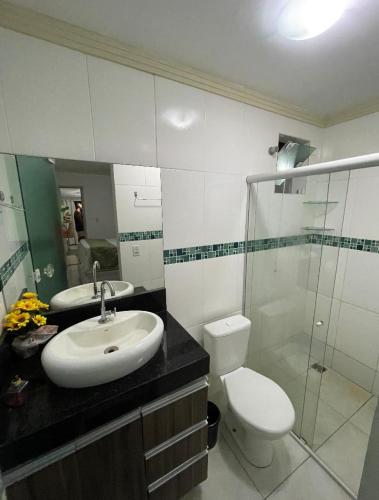 a bathroom with a sink and a toilet and a shower at Residencial Temporada Aracaju in Aracaju