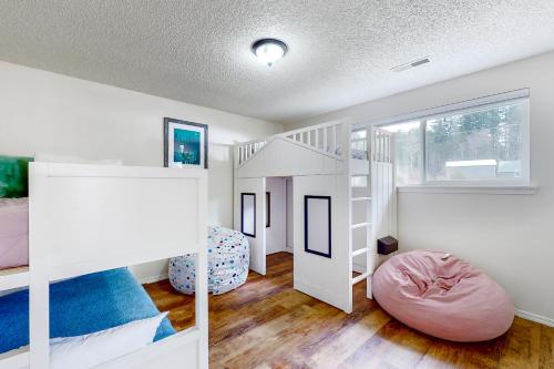 a bedroom with white bunk beds and a large window at Hammersley Inn-let in Shelton