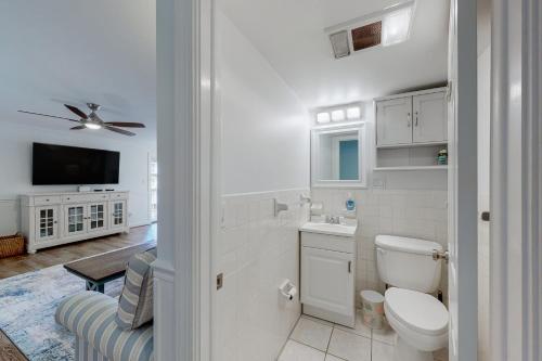 a white bathroom with a toilet and a sink at Aronimink Vista 9C in Ocean City