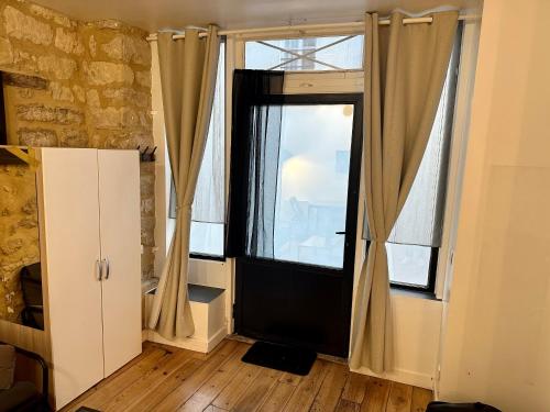 a room with a large window with curtains at Home Sweet Home Le Chapelais Montmartre in Paris