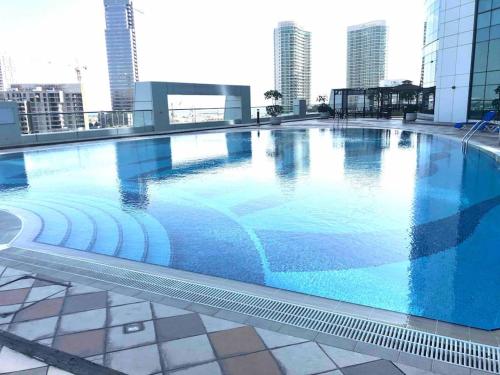 a large swimming pool on the roof of a building at Lovely Private Contemporary Residential Apartment - 201 in Abu Dhabi