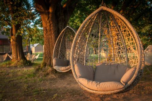 two hanging hammocks sitting next to a tree at Glamping Lucky House in Gradac