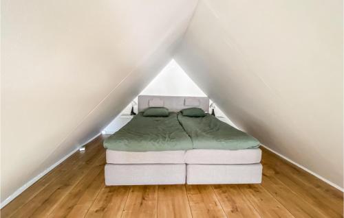 a white bed sitting in the middle of a attic at 2 Bedroom Amazing Home In Gislaved in Gislaved