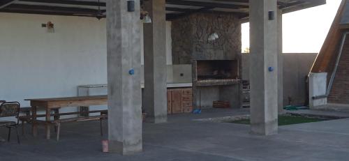 a large room with a table and a fireplace at Las lilas in Zavalla