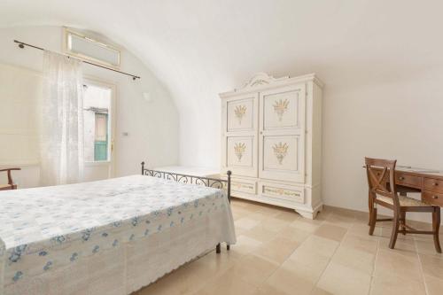 a bedroom with a bed and a desk and a dresser at Appartamento Aldo Moro by BarbarHouse in Tuglie