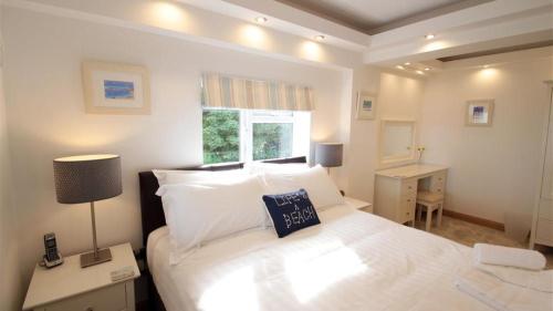 a bedroom with a large white bed and a window at Redcliffe Apartments J in Bishopston