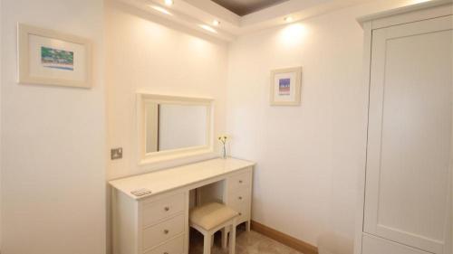 a white bathroom with a sink and a mirror at Redcliffe Apartments J in Bishopston