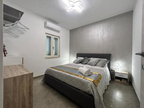 a bedroom with a bed and a ceiling fan at Villaggio al mare in Manfredonia