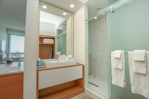 a bathroom with a sink and a shower at Maritime Hotel Fort Lauderdale Airport & Cruiseport in Fort Lauderdale