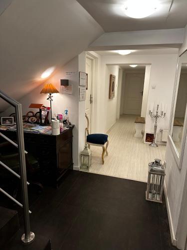 a room with a desk and a chair and a hallway at Pensjonat Jagoda B&B in Międzyzdroje