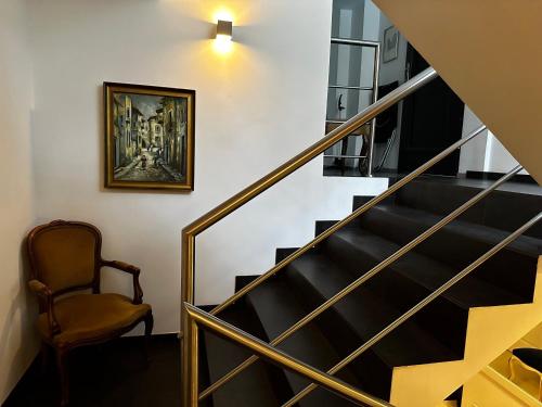 a stairway with a chair and a painting on the wall at Pensjonat Jagoda B&B in Międzyzdroje