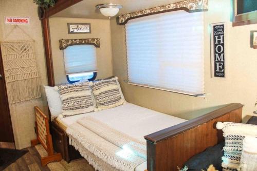 a small bed in a room with a window at Brisas de Isabela Cozy Glamper 1 in Isabela