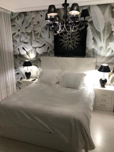 En eller flere senge i et værelse på Ático Lujo Llanes