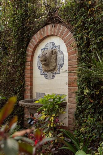 a stone arch with a lion head on a wall at Mansion Alcazar in Cuenca