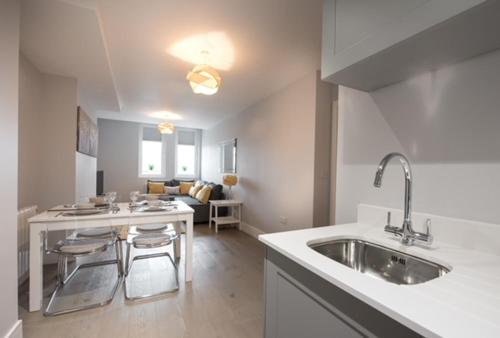 a kitchen with a sink and a counter top at S/KING BED ONE BEDROOM FLAT in Brentwood