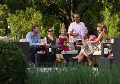 a group of people sitting on chairs in a park at BIRKENHOF GOLS - B & B - Wohlfühl Hotel mit Wochenend-Restaurant in Gols