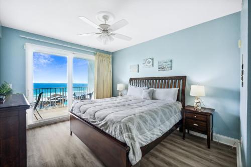 a bedroom with a bed with a view of the ocean at Laketown Wharf #824 by Nautical Properties in Panama City Beach