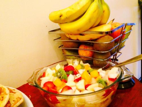 a bowl of fruit with a basket of bananas at Serendipity House in Derry Londonderry