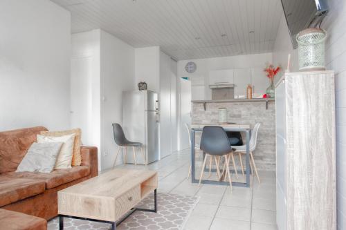 un salon avec un canapé et une table dans l'établissement Appartement cosy au calme, à Aureilhan