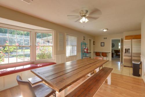 a dining room with a wooden table and windows at The Ranger House Columbus Home Fenced Backyard in Columbus