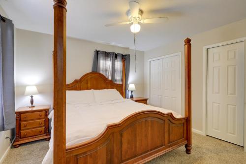 een slaapkamer met een houten bed en een plafondventilator bij The Ranger House Columbus Home with Fenced Backyard in Columbus