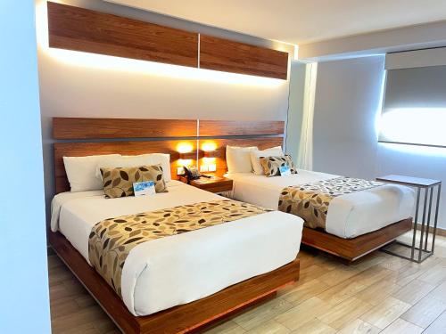 Postel nebo postele na pokoji v ubytování Sleep Inn Tijuana