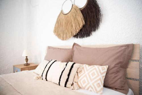 a bedroom with a bed with pillows and a lamp at Sea Breeze Paradise in Paliouri