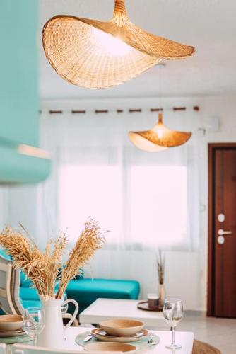 a dining room with a table with a chandelier at Sea Breeze Paradise in Paliouri