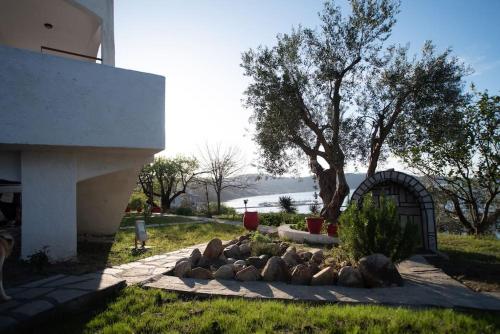 a garden with rocks in front of a house at Sea Breeze Paradise in Paliouri