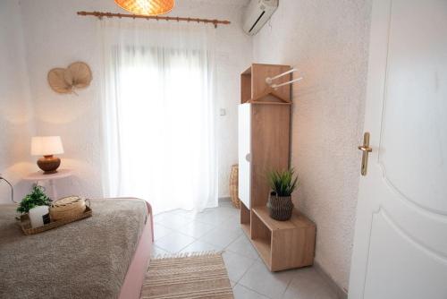 a bedroom with a bed and a large window at Sea Breeze Paradise in Paliouri
