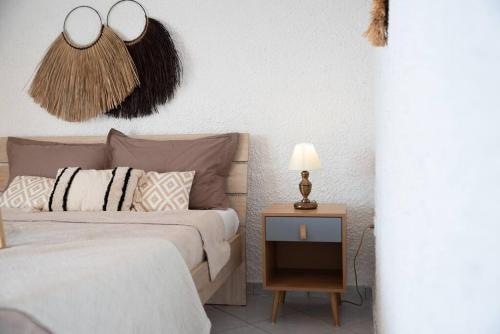 a bedroom with a bed and a table with a lamp at Sea Breeze Paradise in Paliouri
