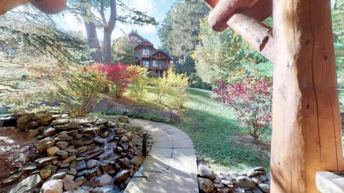 a garden with a stone walkway in front of a house at Oneida Lodge North in Cooperstown