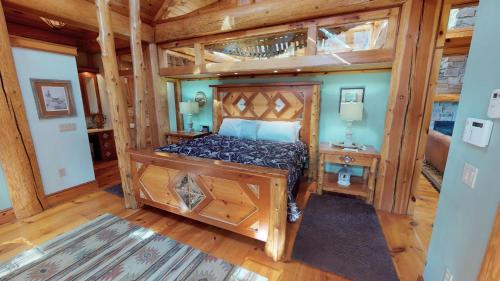 a bedroom with a bed in a room with wooden floors at Cayuga Lodge South in Cooperstown