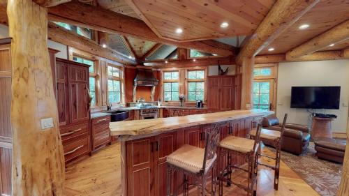 a large kitchen with wooden cabinets and a large island at Oneida Lodge North in Cooperstown