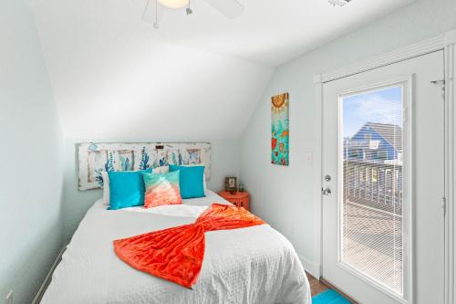a bedroom with a bed and a window at Walk to Beach, Sunset Bay Views, Pet Friendly - Sea Me Relaxin in Surfside Beach