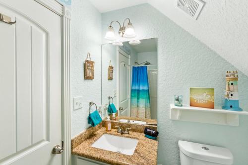 a bathroom with a sink and a mirror at Walk to Beach, Sunset Bay Views, Pet Friendly - Sea Me Relaxin in Surfside Beach