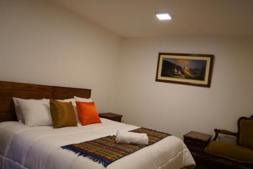 a bedroom with a bed and a picture on the wall at Hotel Colonial - Casa Francisco in Quito