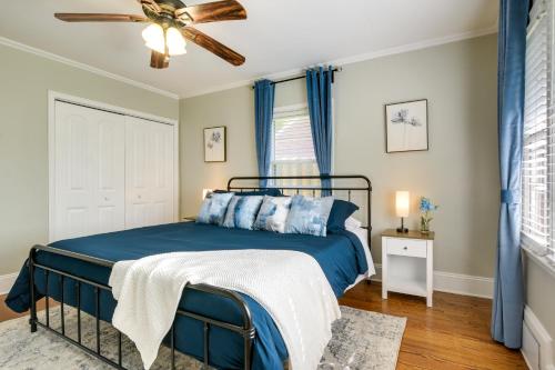 a bedroom with a blue bed and a ceiling fan at Fayetteville Vacation Rental - 1 Mi to Downtown! in Fayetteville