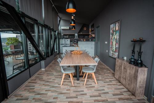 a dining room with a wooden table and chairs at Hotel Grand View in Tbilisi in Tbilisi City
