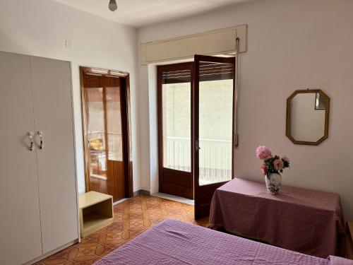 a room with a table and a vase of flowers on a table at Appartamento Policastro Bussentino in Policastro Bussentino