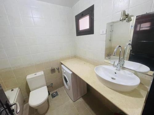 a bathroom with a sink and a toilet at Navy Chalet 108 in Hurghada