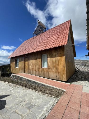a large wooden building with a red roof at Armenian Camp, Sevan in Artanish