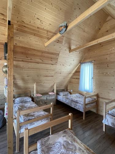 a room with three beds in a log cabin at Armenian Camp, Sevan in Artanish