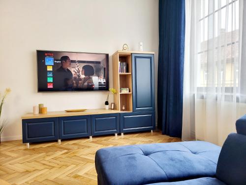 a living room with a tv on a wall at SbOldTown Apartament in Braşov