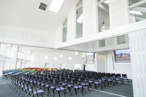 a room with rows of chairs in a building at Hotel GSH in Rønne
