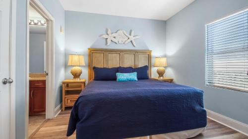 a bedroom with a blue bed with a blue comforter at The Turtle Nest at Laketown Wharf #414 by Nautical Properties in Panama City Beach
