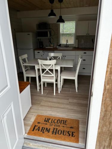 a kitchen with a table and a farm house rug at Maria's Tiny Barn in Homestead