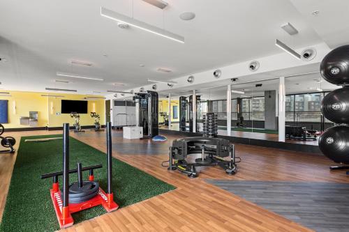a gym with treadmills and exercise equipment in a building at Kasa RiNo Denver in Denver